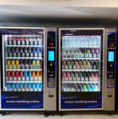 Two vending machines filled with various cans and bottles of beverages.