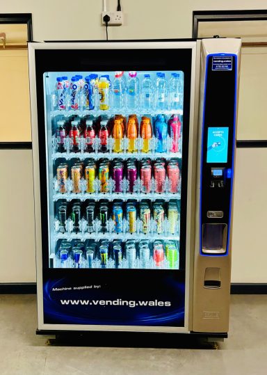 Bev Max Media Vending machine filled with various cold drinks.