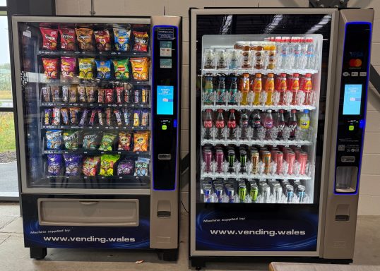 Two vending machines offering snacks and cold beverages.